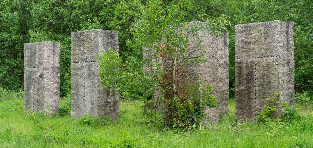 This group of seven tall slabs is installed on a flat plateau © Copyright David Dixon